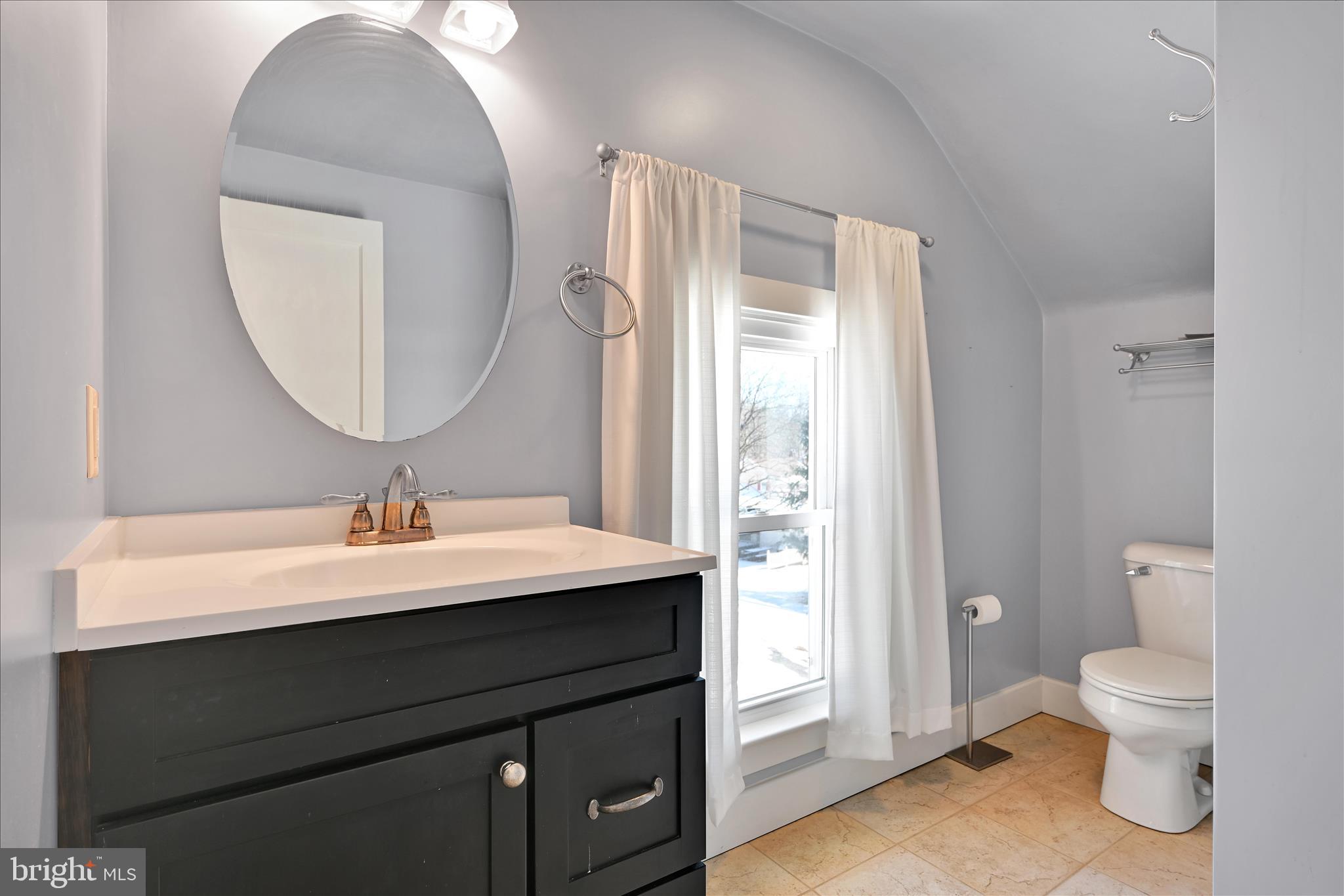 104 Locust Street Annville, PA 17003 - Photo 23 of 43 a bathroom with a sink a toilet and a mirror