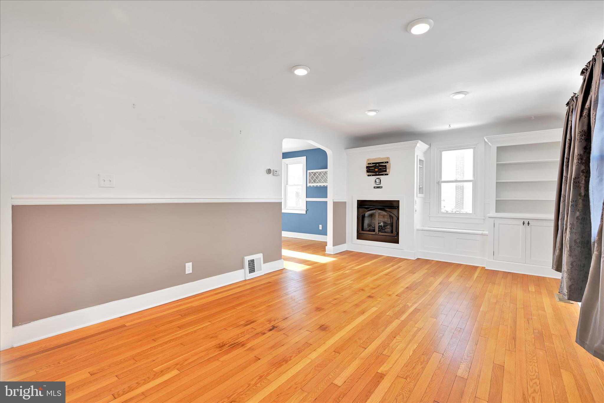 104 Locust Street Annville, PA 17003 - Photo 9 of 43 a view of empty room with wooden floor and fireplace