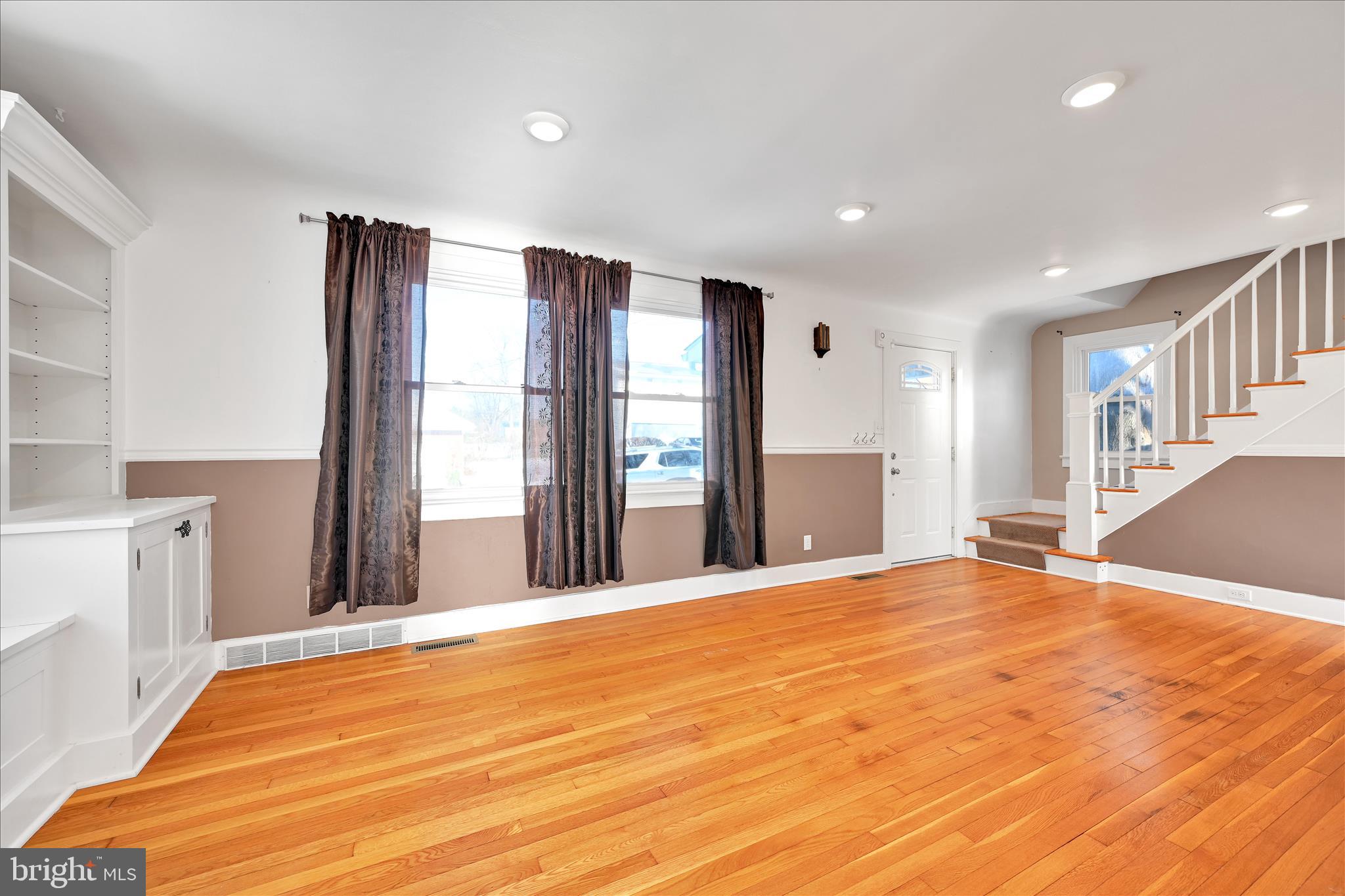 104 Locust Street Annville, PA 17003 - Photo 10 of 43 a view of an empty room with a fireplace and a window