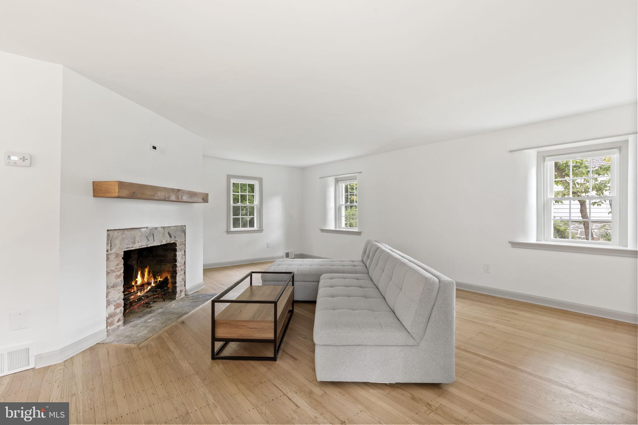 218 Engle Drive Wallingford, PA 19086 - Photo 11 of 51 a living room with furniture and a fireplace