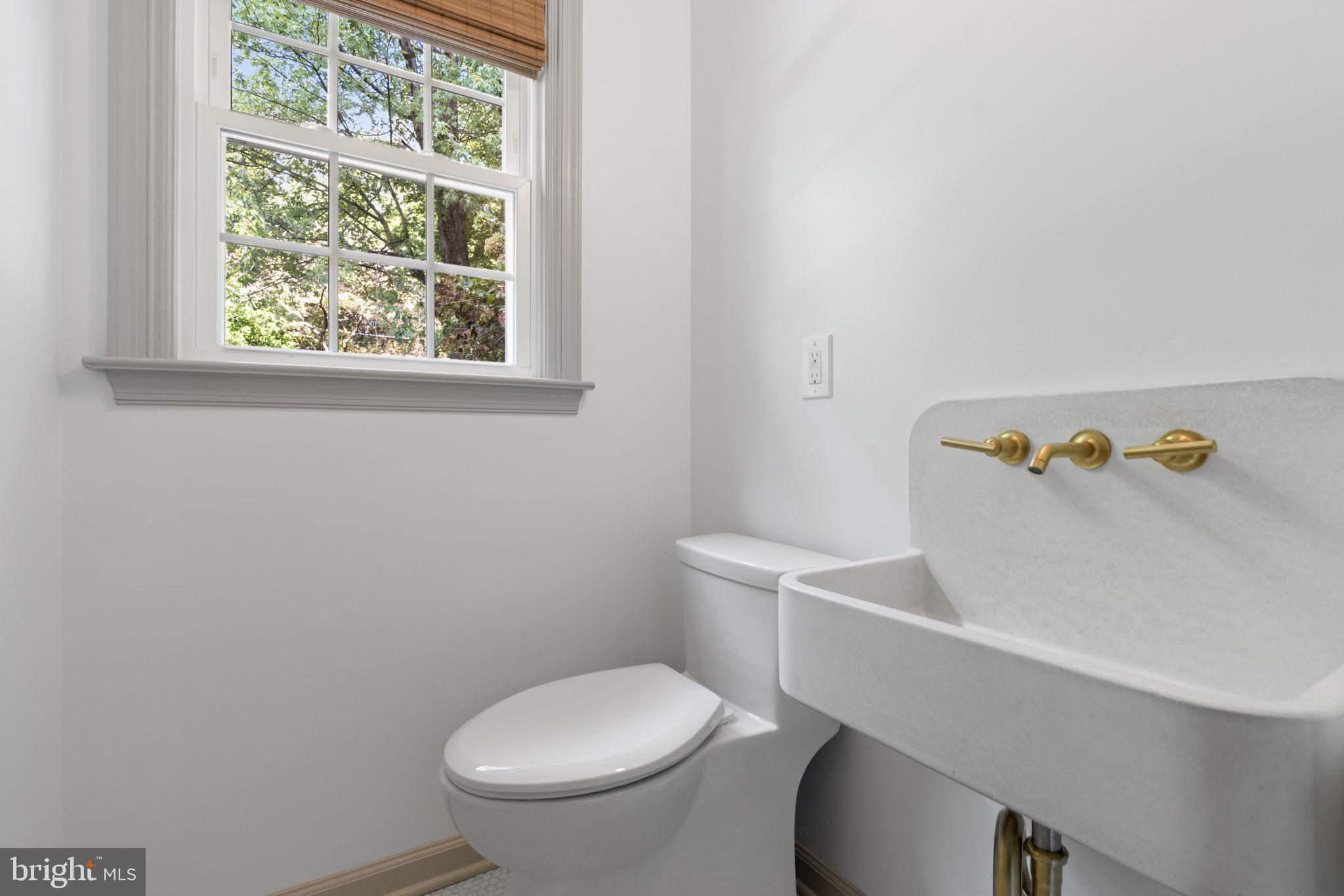 218 Engle Drive Wallingford, PA 19086 - Photo 27 of 51 a white toilet sitting next to a bathroom sink