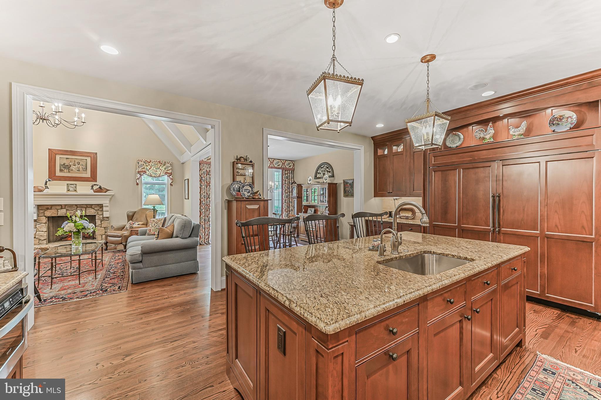 217 Valley Ridge Road Haverford, PA 19041 - Photo 11 of 49 a kitchen with stainless steel appliances granite countertop a sink a oven and wooden floors