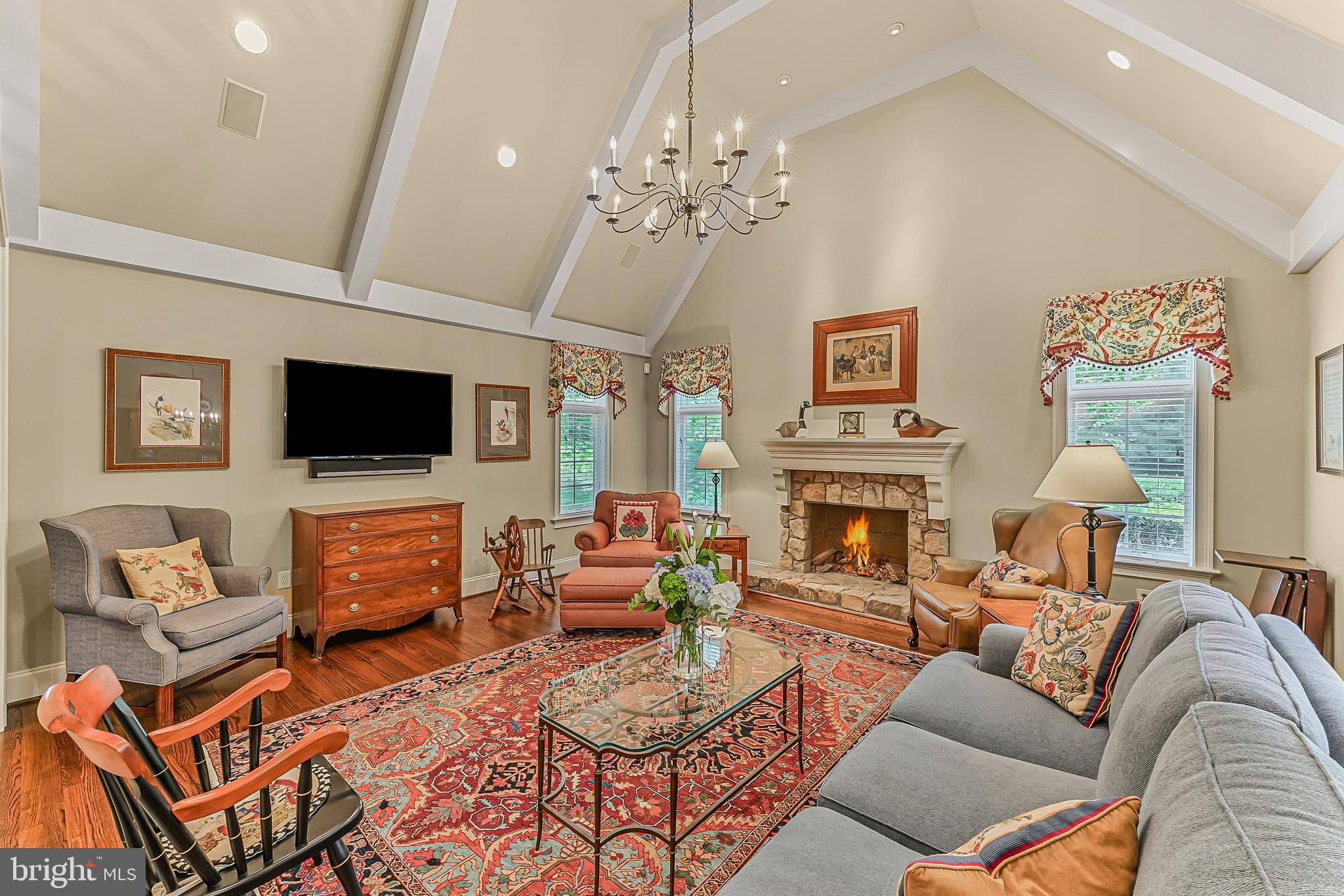 217 Valley Ridge Road Haverford, PA 19041 - Photo 18 of 49 a living room with furniture a flat screen tv and a fireplace