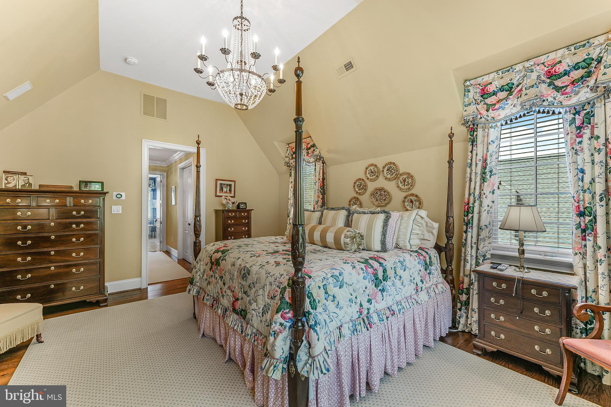 217 Valley Ridge Road Haverford, PA 19041 - Photo 26 of 49 a bedroom with a bed a dresser and a chandelier