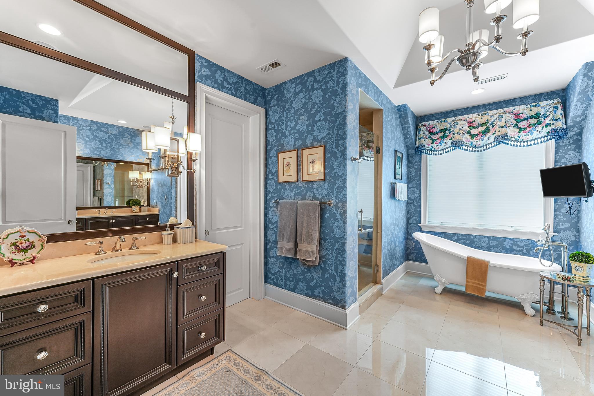 217 Valley Ridge Road Haverford, PA 19041 - Photo 27 of 49 a spacious bathroom with a tub sink and mirror