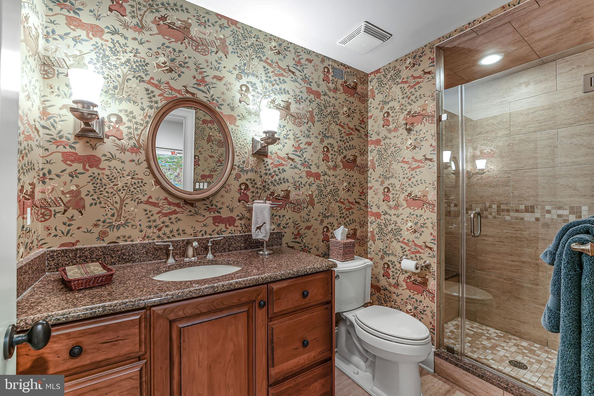 217 Valley Ridge Road Haverford, PA 19041 - Photo 45 of 49 a bathroom with a granite countertop toilet sink and mirror