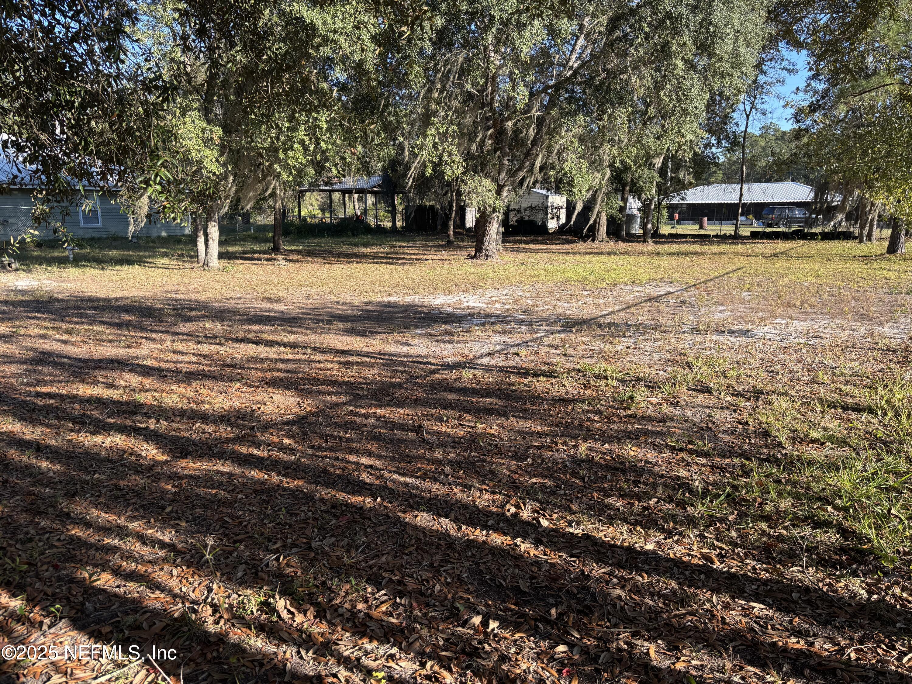 104 Marina Road Satsuma, FL 32189 - Photo 3 of 8 a house with trees in the background