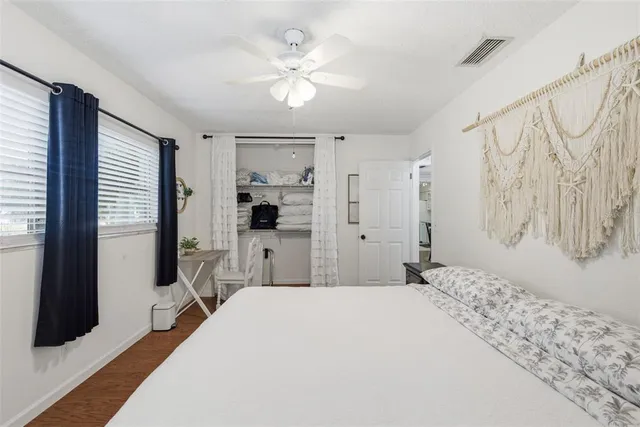 a bedroom with a bed and wooden floor