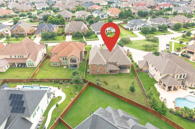 an aerial view of residential houses with outdoor space