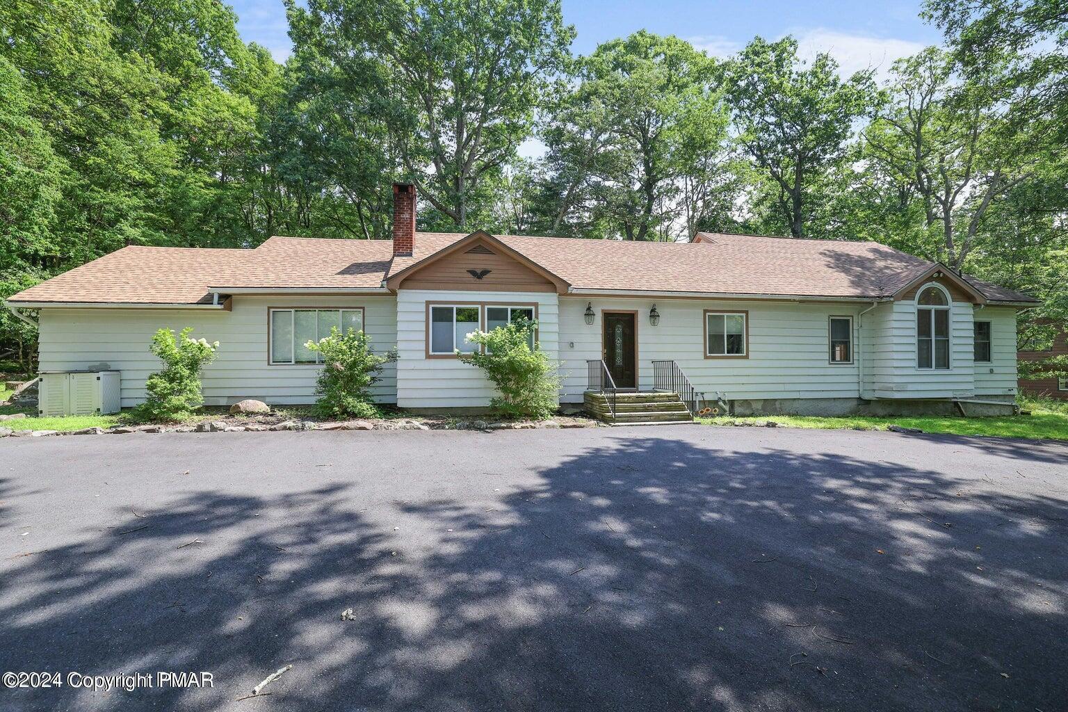 755 White Oak Road Cresco, PA 18326 - Photo 1 of 50 a front view of a house with a garden