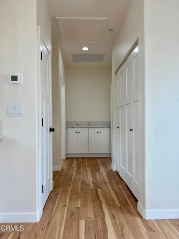 a view of empty room with wooden floor