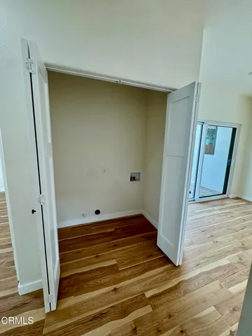 a view of storage and utility room with wooden floor