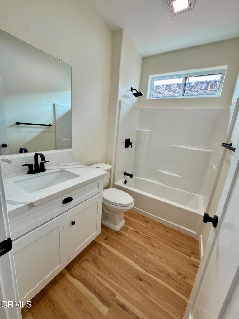 1170 West 1st Street Oxnard, CA 93030 - Photo 17 of 27 a bathroom with a sink a toilet and shower