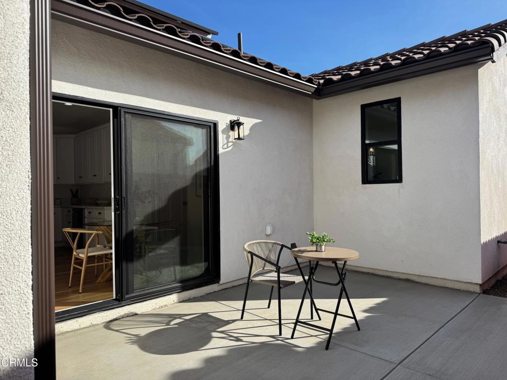 1170 West 1st Street Oxnard, CA 93030 - Photo 26 of 27 a balcony with table and chairs
