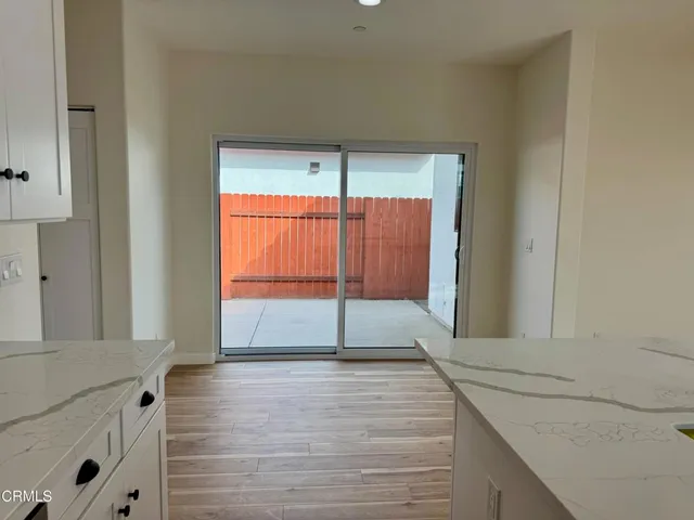 a view of a room with wooden floor and a bathroom