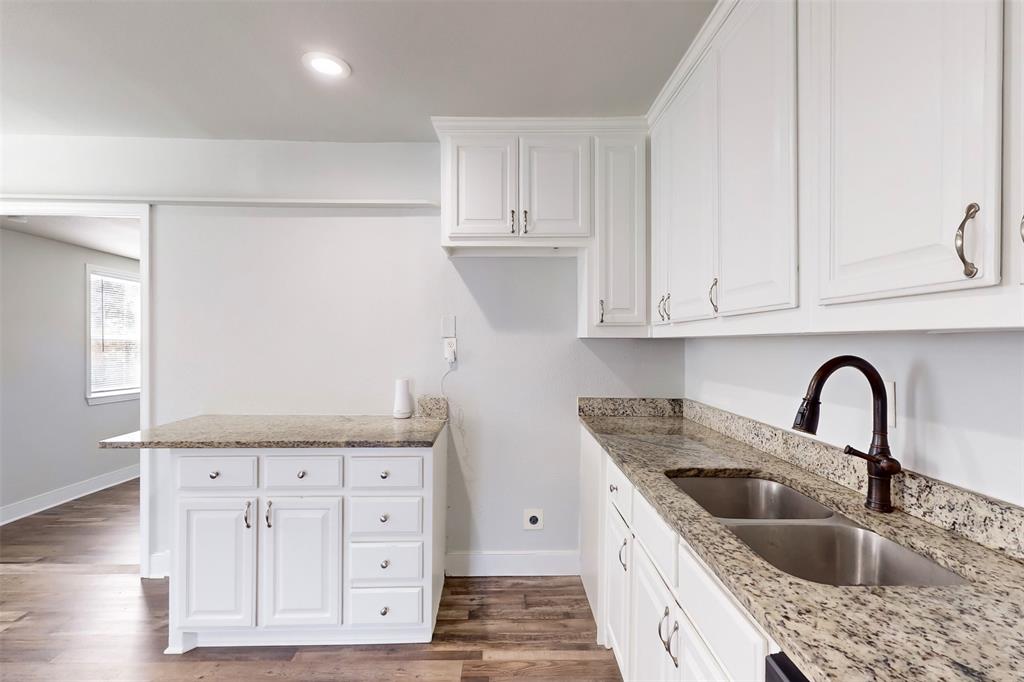 2667 Custer Drive Dallas, TX 75216 - Photo 11 of 33 a kitchen with granite countertop a sink a stove and cabinets