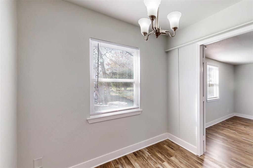 2667 Custer Drive Dallas, TX 75216 - Photo 13 of 33 a view of an empty room with wooden floor and a window
