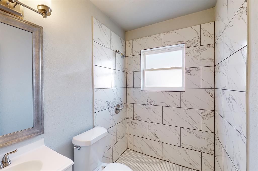 2667 Custer Drive Dallas, TX 75216 - Photo 26 of 33 a bathroom with a toilet and a shower