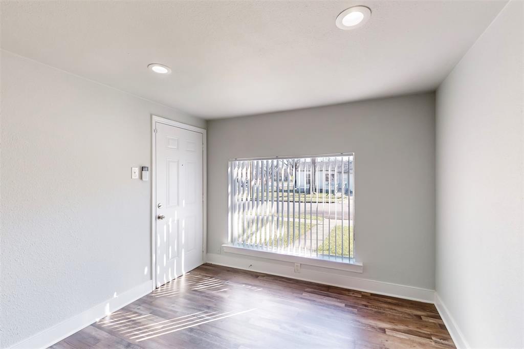 2667 Custer Drive Dallas, TX 75216 - Photo 5 of 33 a view of an empty room with wooden floor and a window