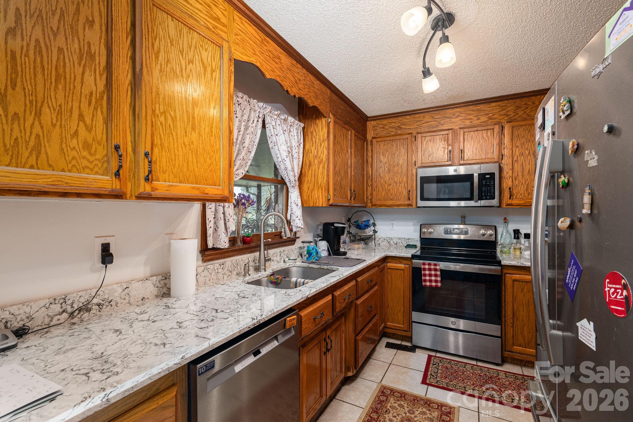 3815 Wildcherry Road Shelby, NC 28150 - Photo 12 of 33 a kitchen with stainless steel appliances granite countertop a sink stove and microwave