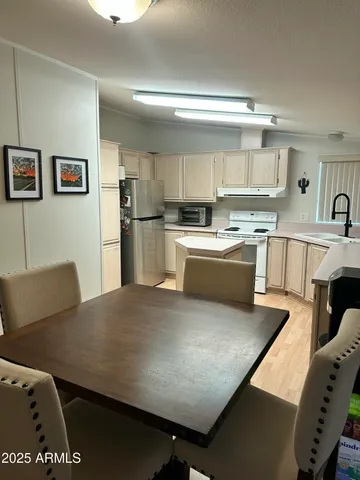 a view of kitchen with sink microwave and refrigerator