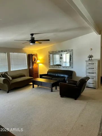 a living room with furniture and a pool table