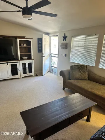 a living room with furniture and a flat screen tv