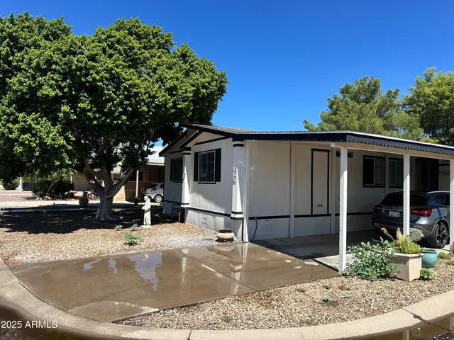 a view of a house with a backyard