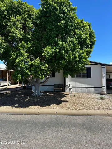 a house that has a tree in front of it