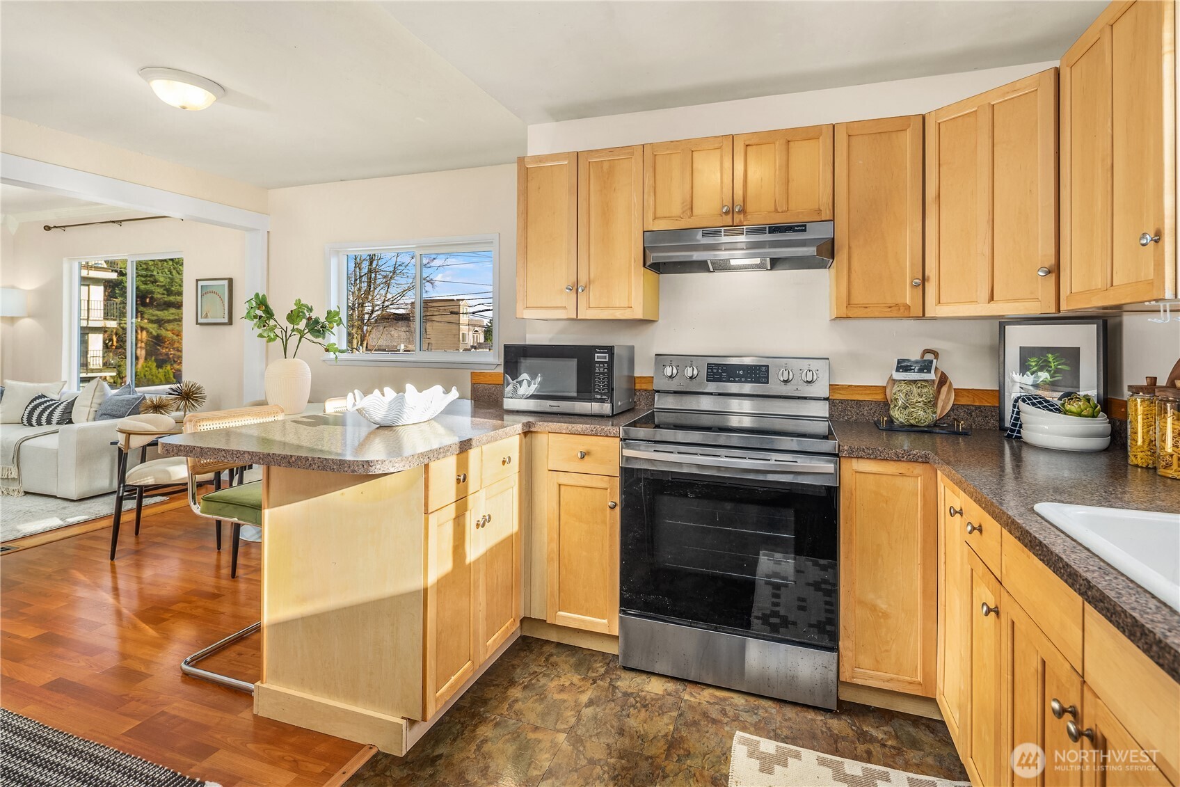151 North 77th Street Seattle, WA 98103 - Photo 11 of 27 a kitchen with stainless steel appliances granite countertop a stove top oven a sink dishwasher and cabinets with wooden floor
