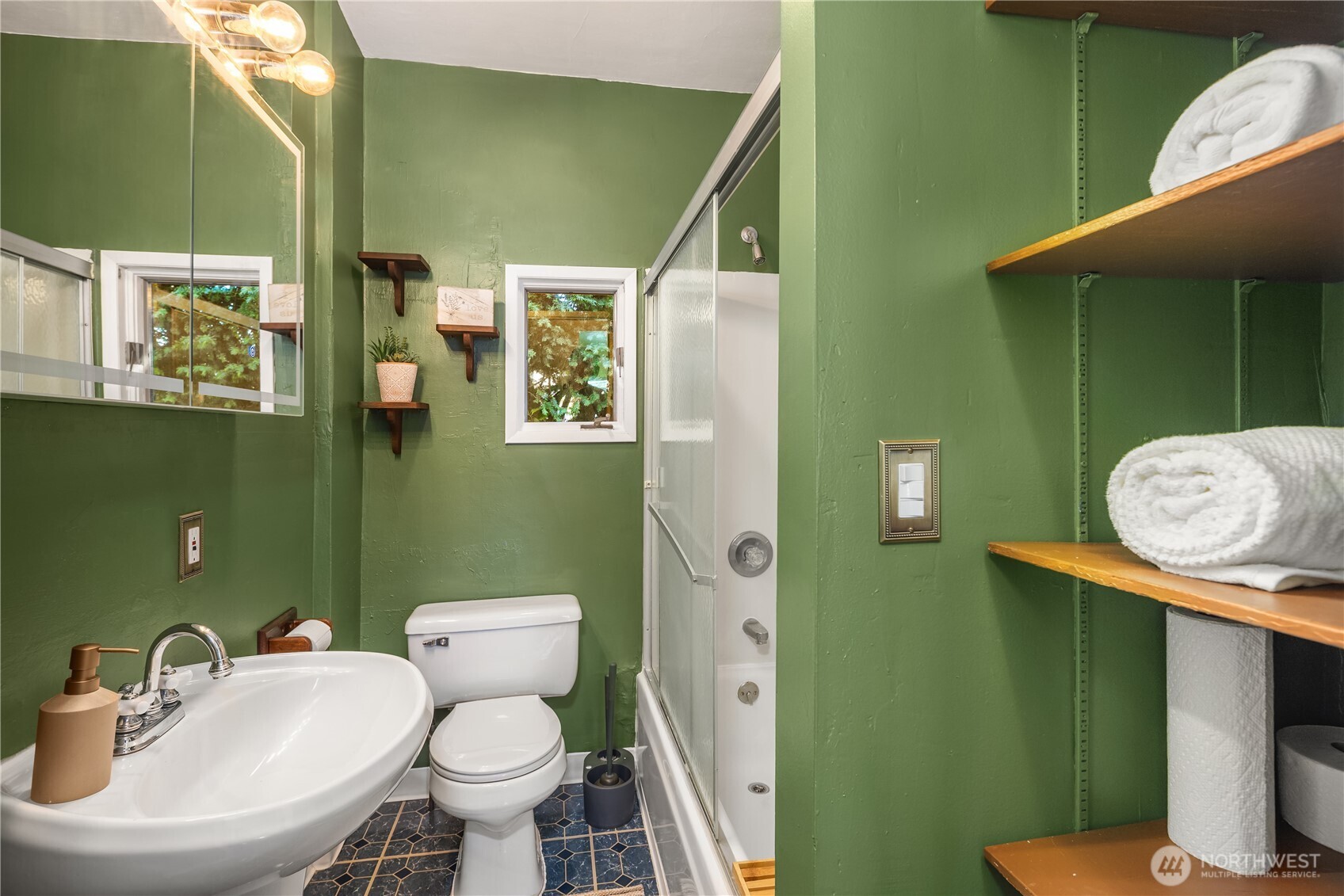 151 North 77th Street Seattle, WA 98103 - Photo 15 of 27 a bathroom with a toilet sink and mirror