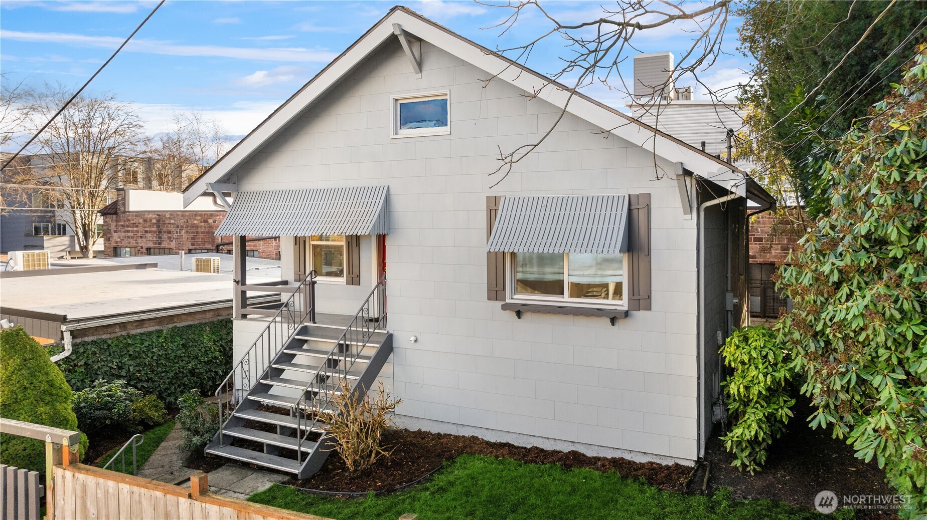 151 North 77th Street Seattle, WA 98103 - Photo 24 of 27 a front view of house with yard outdoor seating and mountain view in back