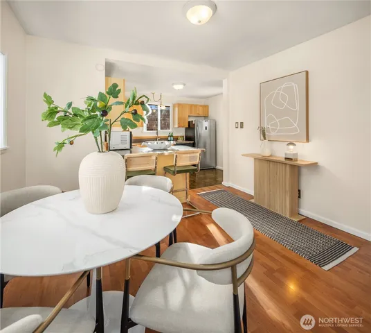 a dining room with furniture and wooden floor