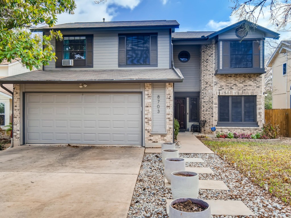 a view of a house with a yard and garage