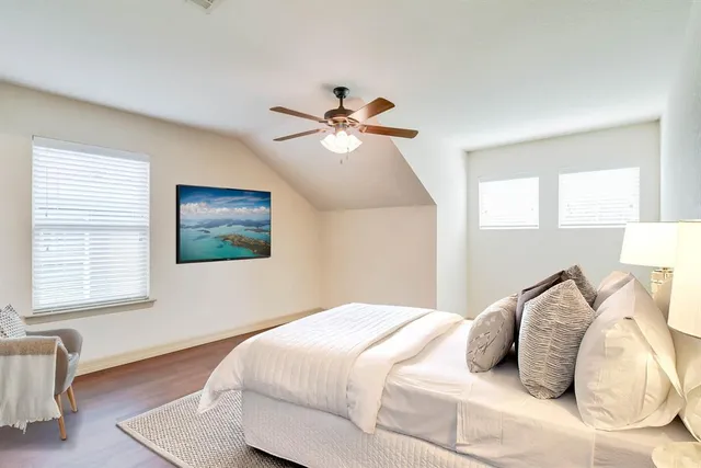 a bedroom with a bed and a chandelier