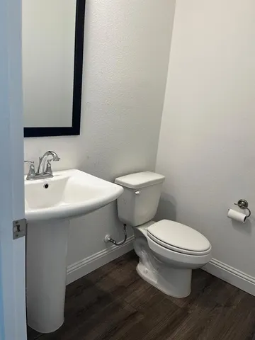 a white toilet sitting next to a bathroom sink