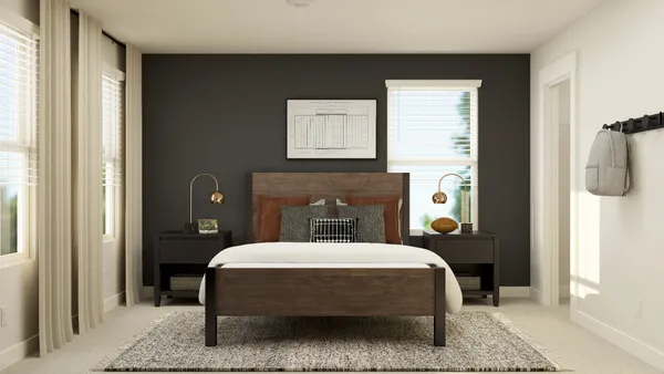 a bedroom with a bed and a painting on the wall