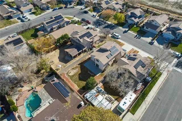 an aerial view of a residential apartment building with a yard