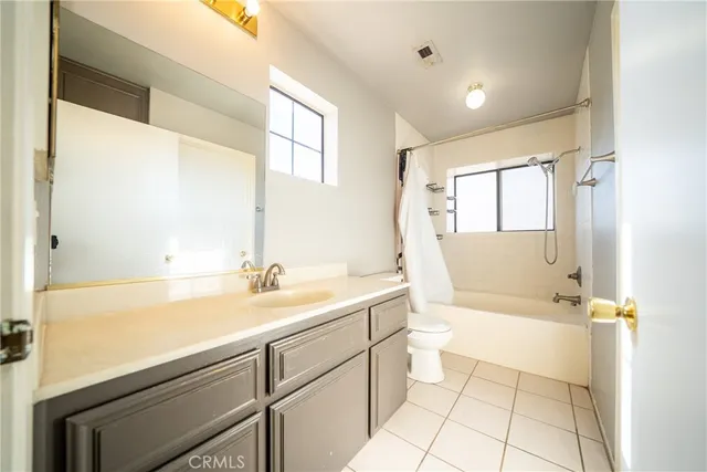 a spacious bathroom with a sink mirror toilet and bathtub