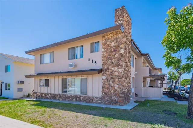 a front view of a house with a garden and yard