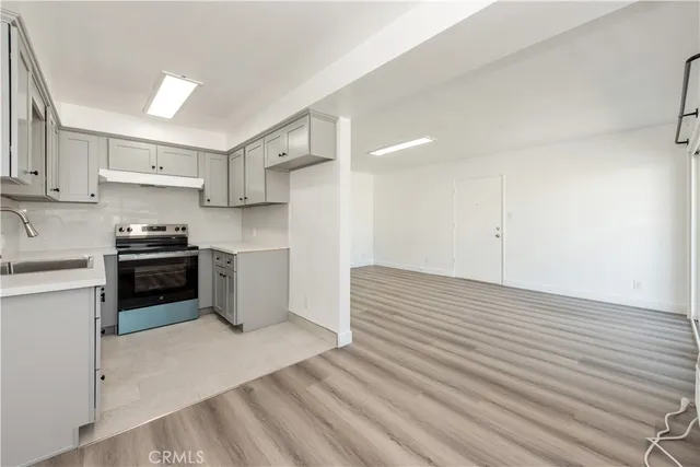 a kitchen with a sink and a stove top oven