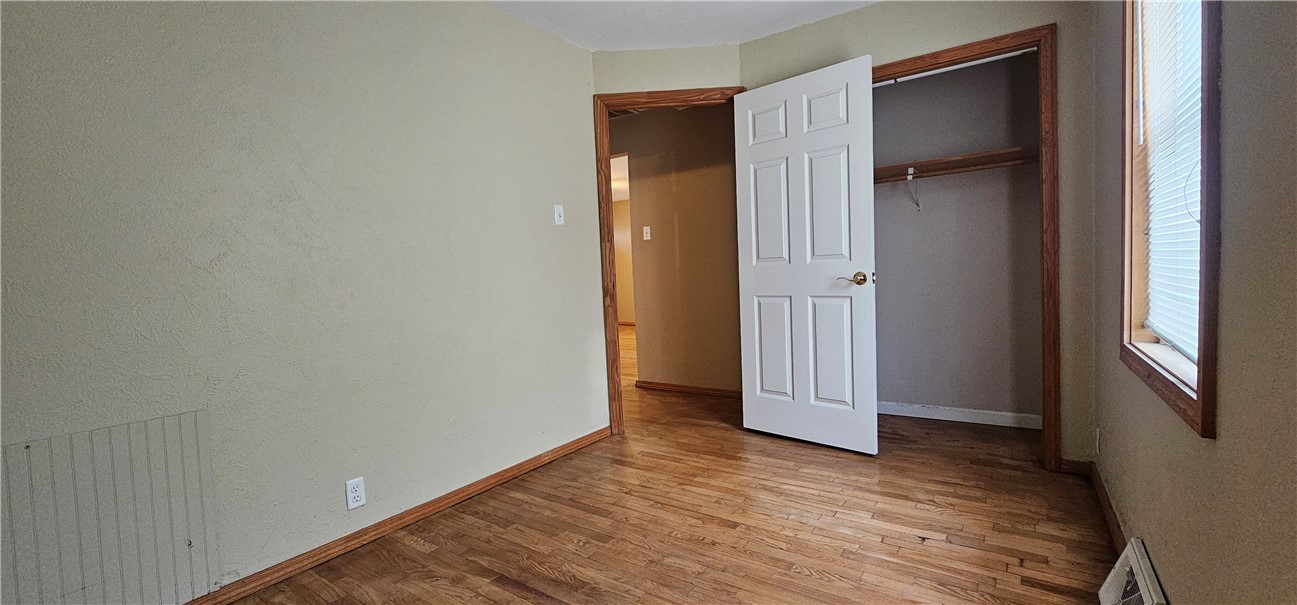 206 East Fifth Street St. Peter, IL 62880 - Photo 17 of 23 an empty room with wooden floor and windows