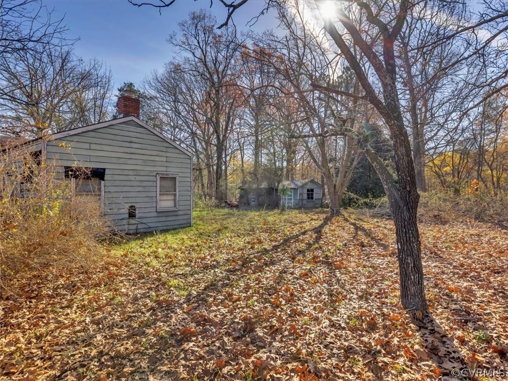 9601 Cattail Road Chesterfield, VA 23838 - Photo 3 of 16 a backyard of a house with large trees
