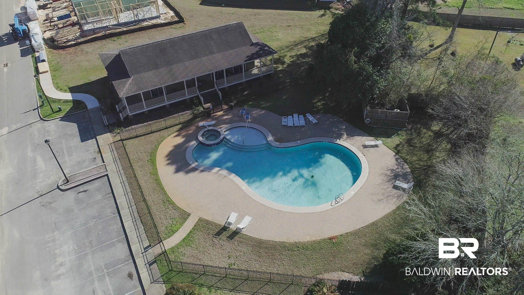 25806 Pollard Road, Unit 24 Daphne, AL 36526 - Photo 29 of 33 Aerial view of property and surrounding area with a pool area