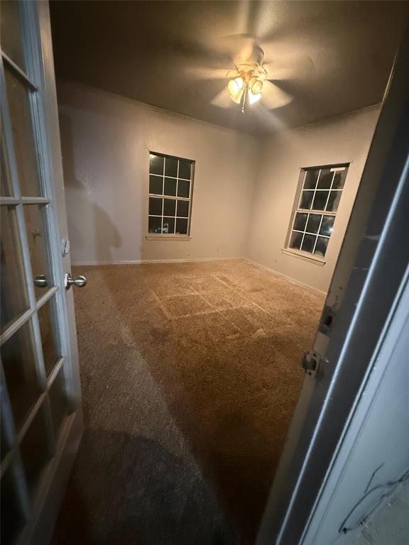 609 Elwayne Avenue Dallas, TX 75217 - Photo 3 of 4 Spare room with carpet floors and a ceiling fan