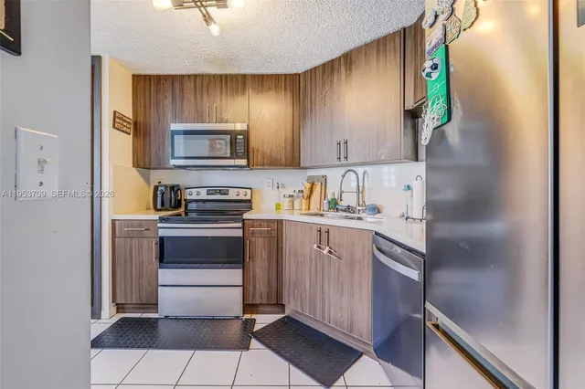 a kitchen with a sink cabinets and stainless steel appliances