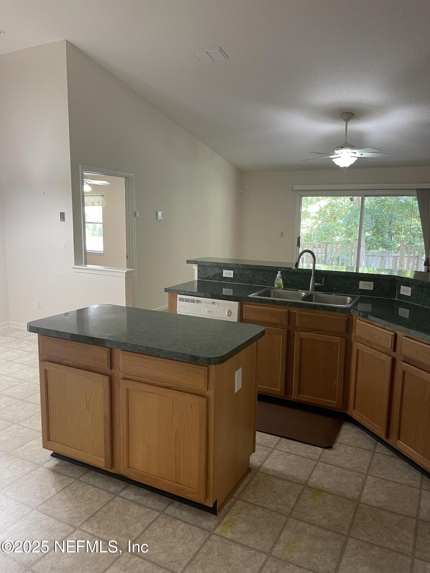12551 Arrowleaf Lane Jacksonville, FL 32225 - Photo 3 of 14 a kitchen with a sink and a stove top oven