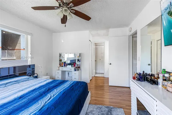 a room with a bed and a mirror on the dresser