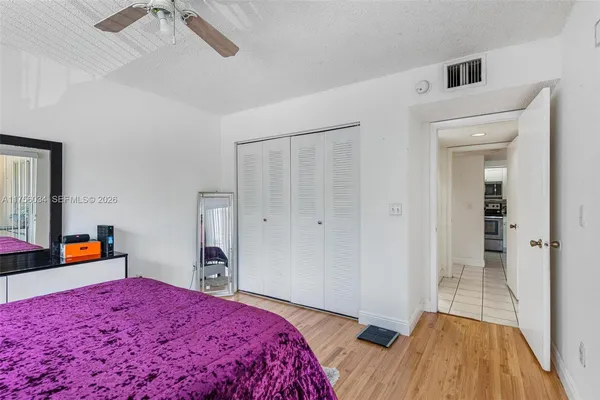 a bedroom with a bed and a dresser in it