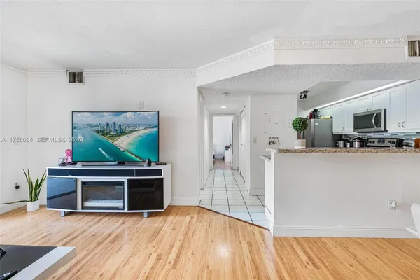 a view of empty room with wooden floor and fireplace